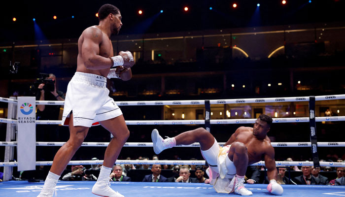 Anthony Joshua (left) knocks down Francis Ngannou at Kingdom Arena, Riyadh, Saudi Arabia on March 9, 2024. — Reuters