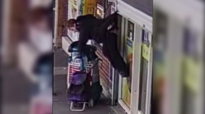 WATCH: Woman hanging in air after getting stuck on shutter claims TikTok fame