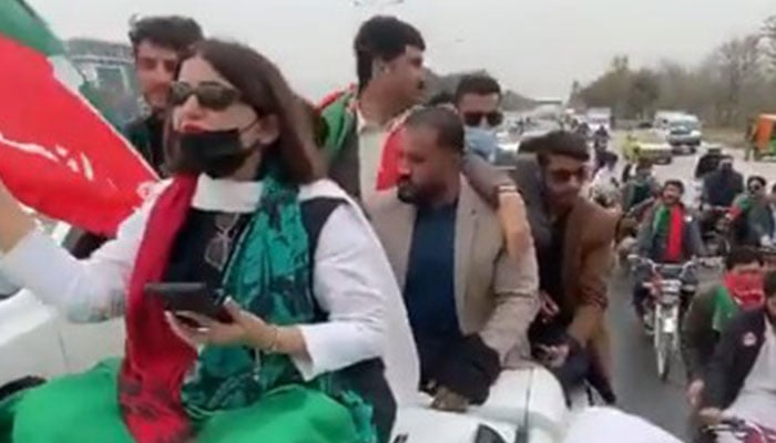 PTIs Seemabia Tahir is seen sitting on top of a vehicle as she leads a protest rally in Rawalpindi on March 10, 2024. — Screengrab/X/balochi5252