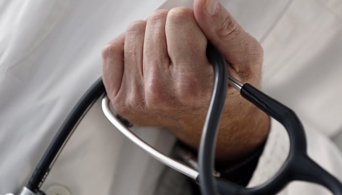 A photo illustration shows a general practitioner holding a stethoscope in a doctors office. — Reuters/File