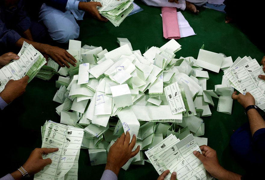 Polling staff count votes following the end of voting time during general elections in Pakistan. — Reuters/File