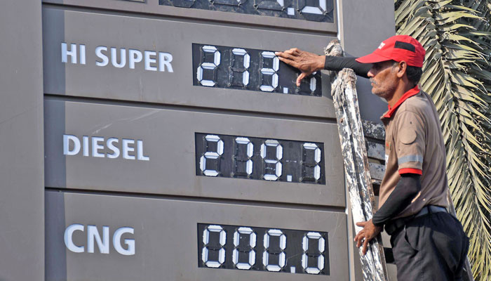 An employee updates the fuel prices at a fuel station after the interim government increased the petrol price by Rs 13.55 per litre with effect from February 1, 2024. — Online