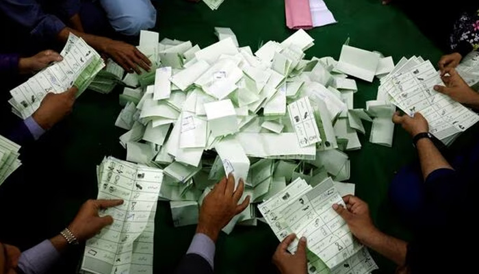 Election officials count ballots after polls closed during the general election in Islamabad, Pakistan, on July 25, 2018. — Reuters