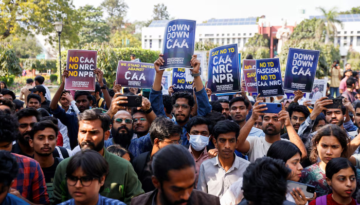 Students of Jamia Millia Islamia University from different student organizations hold placards against a citizenship law during a press conference held inside the university in New Delhi, India, March 12, 2024. — Reuters