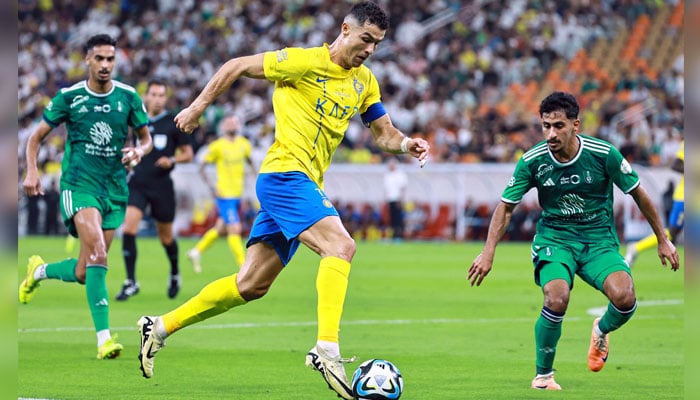 Al Nassrs Cristiano Ronaldo in action with Al Ahli s Saad Yaslam Balobaid during Saudi Pro League match against Al Ahli at King Abdullah Sports City, Jeddah, Saudi Arabia on March 15, 2024. — Reuters