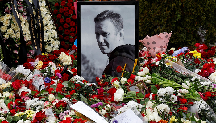 A portrait of Russian opposition politician Alexei Navalny is placed amid flowers at his grave the day after the funeral at the Borisovskoye cemetery in Moscow, Russia, March 2, 2024. — Reuters
