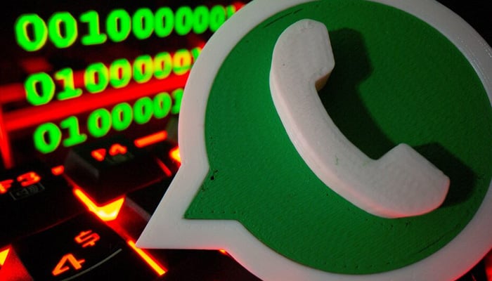 A 3D printed WhatsApp logo is pictured on a keyboard in front of binary code in this illustration taken September 24, 2021. — Reuters