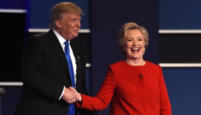 The then-Democratic nominee Hillary Clinton (R) shakes hands with Republican nominee Donald Trump after the first presidential debate at Hofstra University in Hempstead, New York on September 26, 2016. — AFP