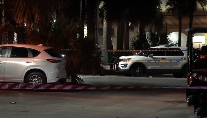 This still taken from a video released on March 17, 2024, shows a Police vehicle parked among others as authorities cordoned off an area after multiple shootings in Jacksonville Beach, Florida. — News4Jax