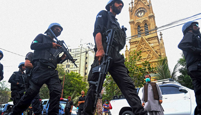 A representational image showing police commandoes walking past by Karachis Merewether Clock Tower. — AFP/File