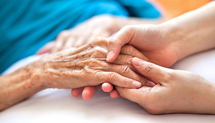 This image shows an individual holding an old persons hand. — Pixabay