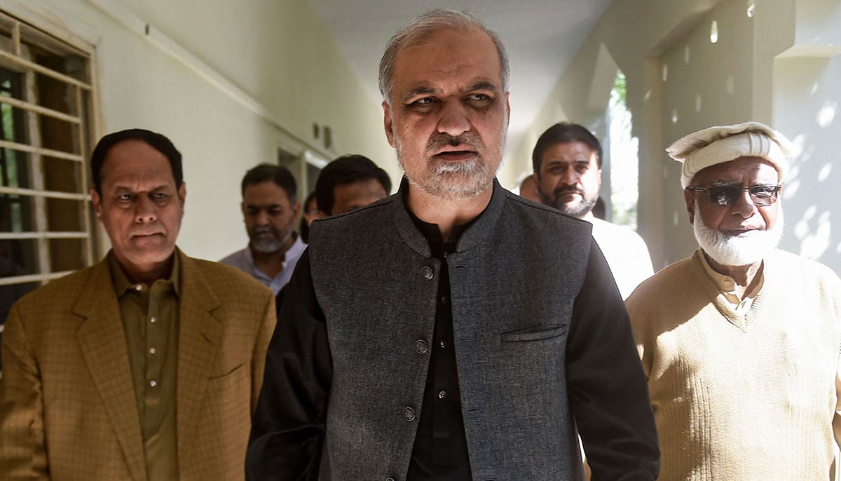 Hafiz Naeem ur Rehman (centre) arrives to submit nomination papers at the deputy commissioner office in Karachi on December 22, 2023, ahead of the upcoming 2024 general elections. — AFP