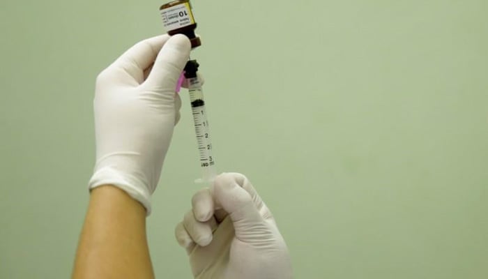 A health agent prepares a vaccine. — Reuters