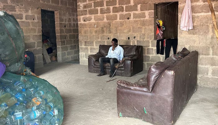 Kehinde Olubotusun sits in his house in Alimosho local government district in Lagos, Nigeria February 23, 2024. — Reuters