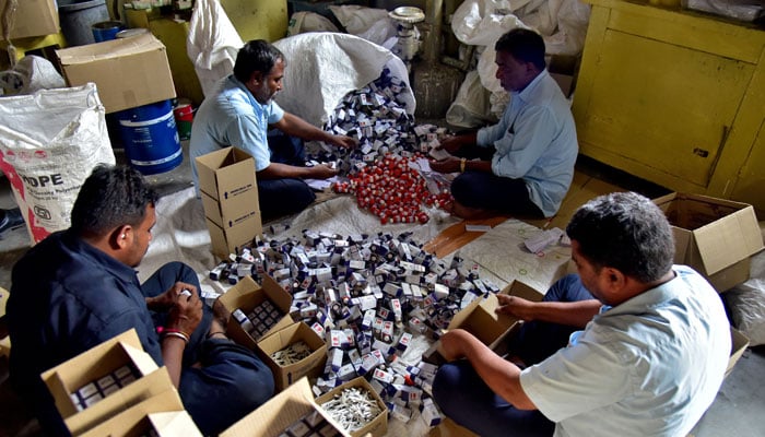 Workers pack indelible ink vials that are used during elections to prevent duplication of voting, at the government-run Mysore Paints and Varnish company in Mysuru, India, March 12, 2024. —Reuters