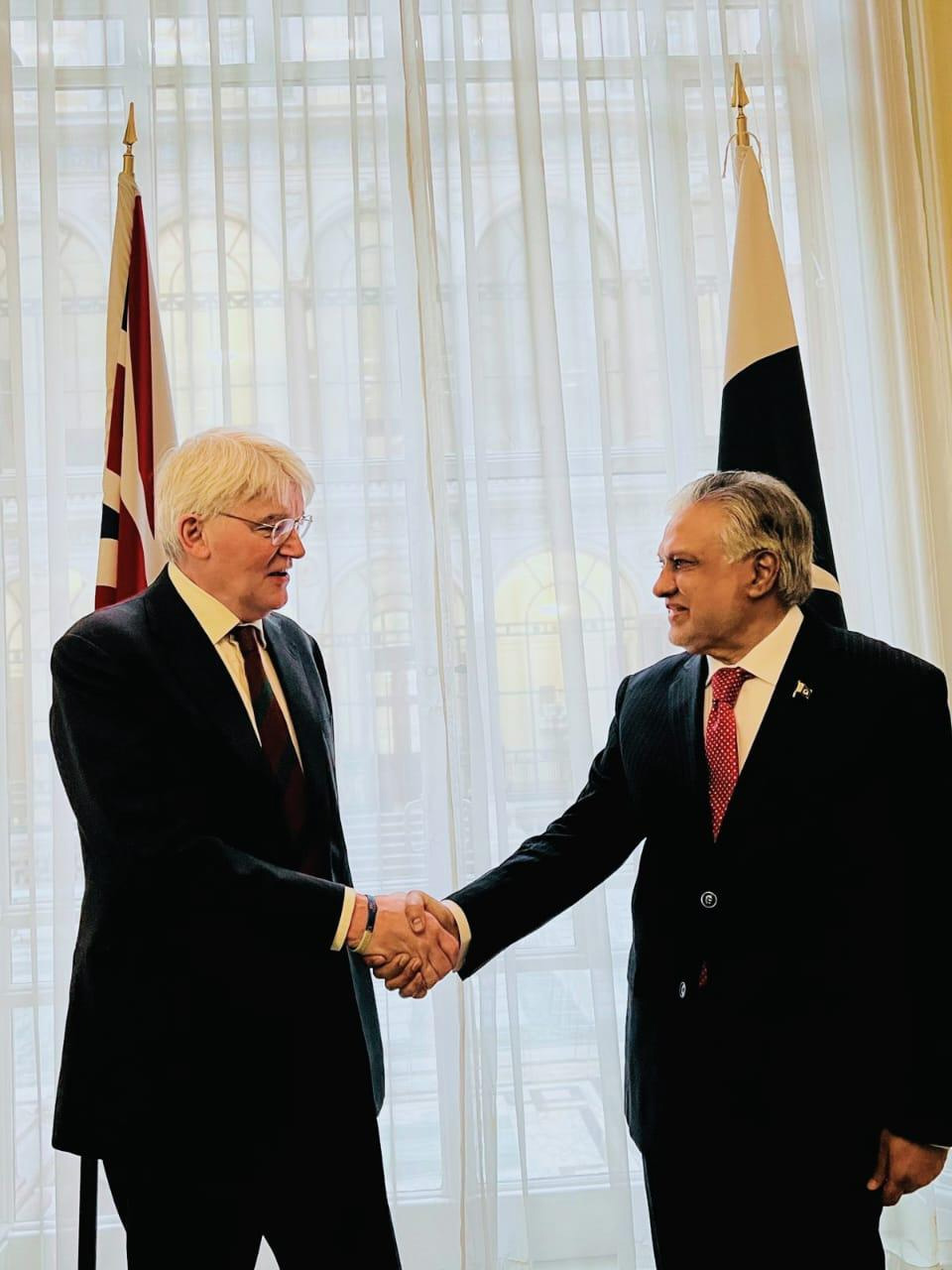 Foreign Minister Ishaq Dar (right) shakes hand with UK Minister of State for Development, Andrew Mitchell in London. — Reporter.