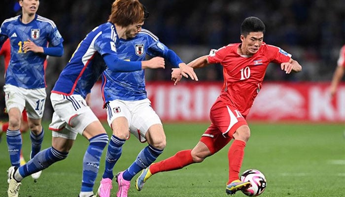 North Korea s forward Han Kwang Song (right) fights for the ball with Japan s defender Shogo Taniguchi (centre) during World Cup 2026 qualifier football match between Japan and North Korea at the National Stadium in Tokyo on March 21, 2024. — AFP