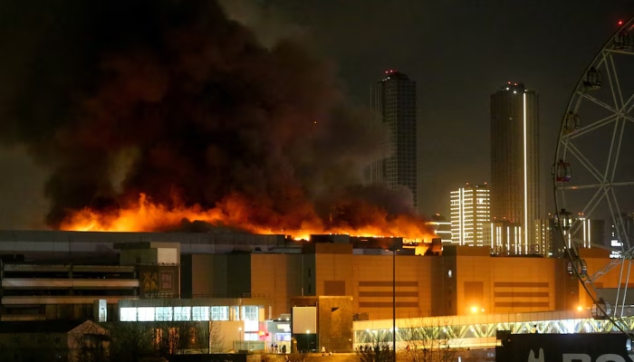 Smoke rises above the burning Crocus City Hall concert venue following a reported shooting incident, outside Moscow, Russia, March 22, 2024. —Reuters