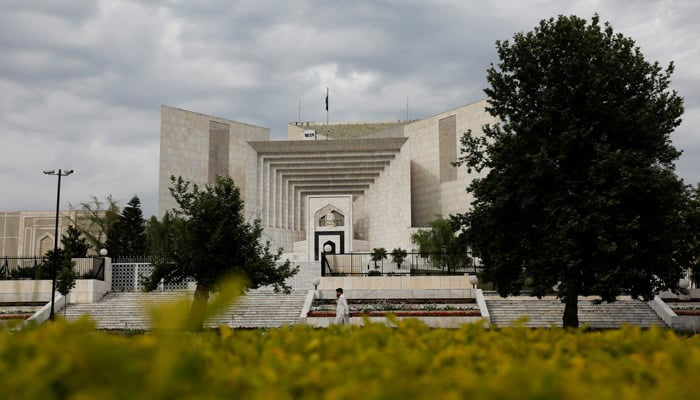A man uses his mobile phone as he walks past the Supreme Court of Pakistan building in Islamabad, Pakistan May 13, 2023. — Reuters