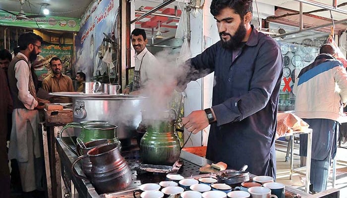 A vendor making tea for customers in a local hotel at Islamabad’s Aabpara Market. — APP