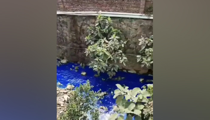 This screengrab from a video released by Asia Wire shows the blue-coloured water in a river in the Chinese city of Dongguan. — Metro UK