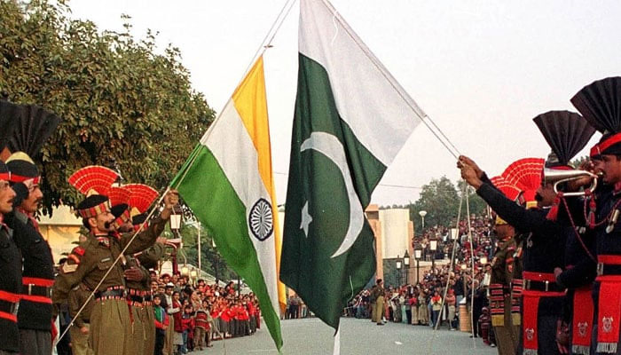 Pakistani border guards (right) and their Indian counterparts take part in the daily closing ceremony of the Wagah border crossing near Lahore, Pakistan. — Reuters/File