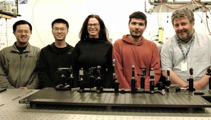 INRS researchers who authored the studyincluding lead professor Jinyang Liang (far left) pose with SCARF. — INRS