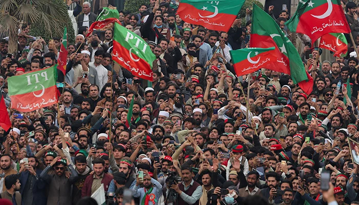 Supporters of PTI wave flags as they protest demanding free and fair results of the elections, in Peshawar, on February 17, 2024. — Reuters