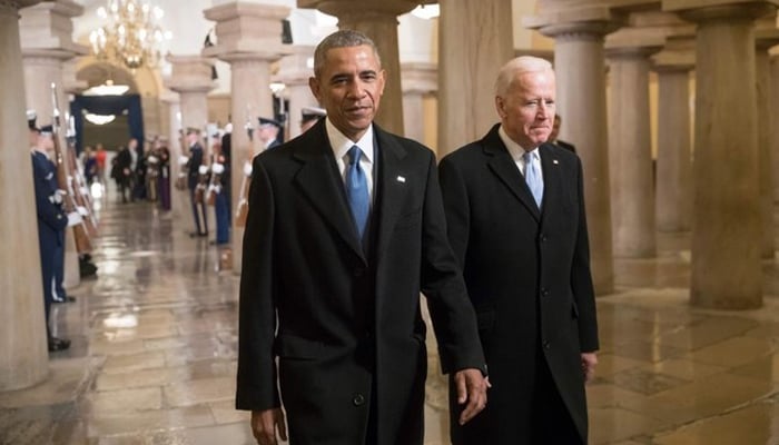 The then-US president Barack Obama and the then-Vice President Joe Biden walk through the Crypt of the Capitol for Donald Trump’s inauguration ceremony, in Washington, DC. — AFP