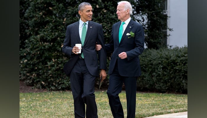 US President Joe Biden (R) holds the arm of former president Barack Obama in this image released on March 17, 2024. — Instagram/@joebiden