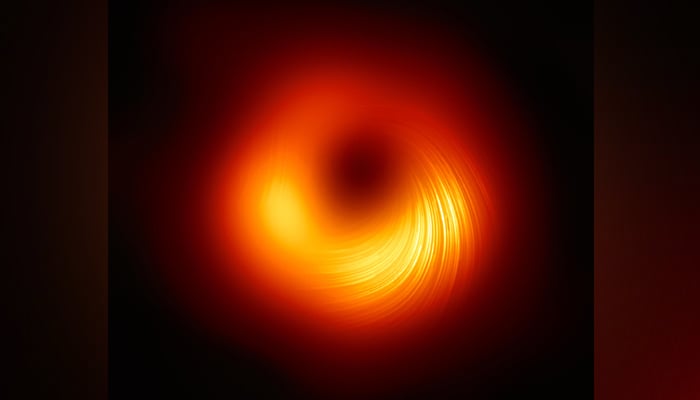 This image released on March 24, 2021, shows a view of the M87 supermassive black hole in polarised light produced by The Event Horizon Telescope (EHT) collaboration, which produced the first image of a black in 2019. — EHT Collaboration