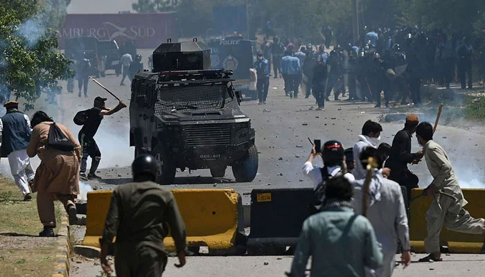 PTI activists and supporters clash with police during a protest against the arrest of their leader, in Islamabad on May 10, 2023. — AFP