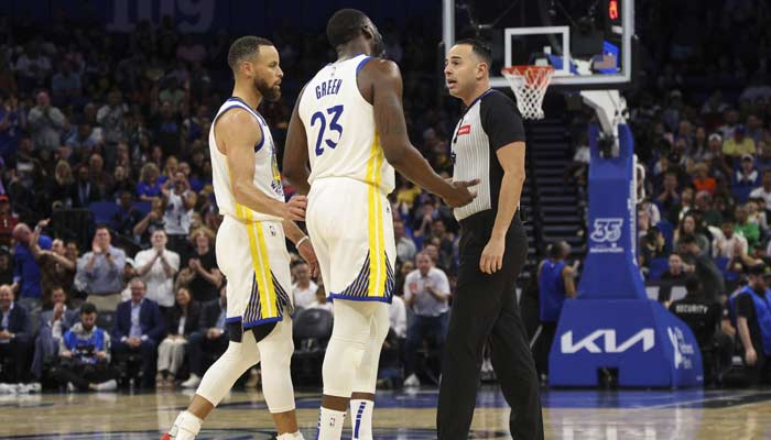 Golden State Warriors forward Draymond Green (23) talks to referee Ray Acosta (54) after receiving a foul in the first quarter at the Kia Center in Orlando, Florida, US on March 27, 2024. — Reuters