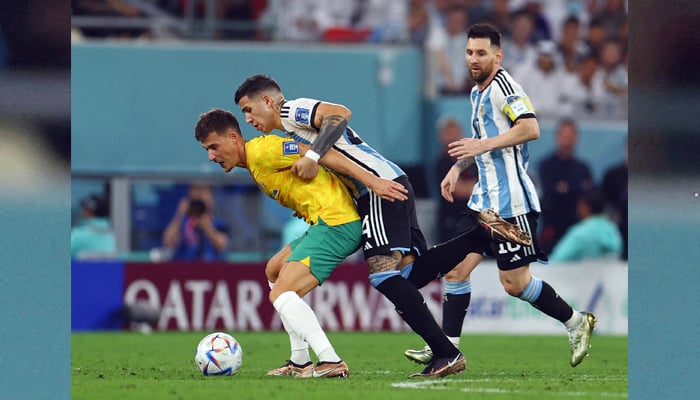 Australias Ajdin Hrustic in action with Argentinas Enzo Fernandez and Lionel Messi on December 3 2022. — Reuters