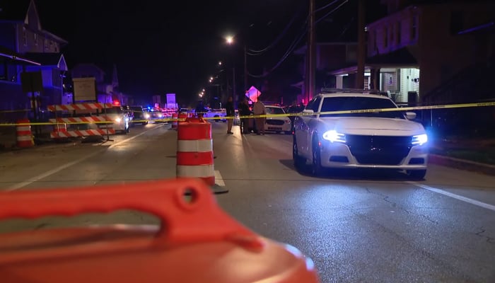 This still taken from a video released on March 30, 2024, shows a police vehicle passing from a crime scene outside Circle Centre Mall in Indiana. Shooting outside mall in Indiana leaves seven children injured. — YouTube/WTHR 13