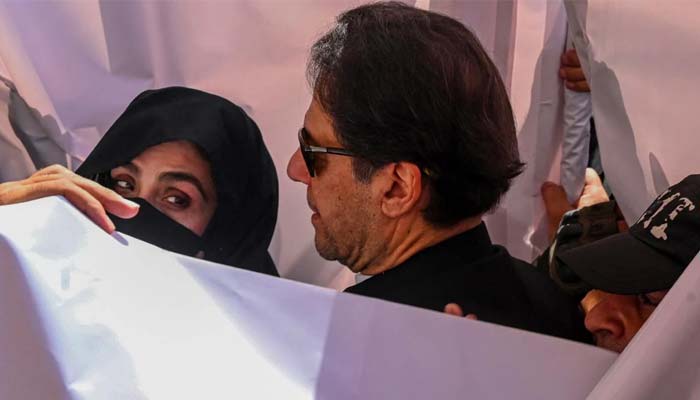 Imran Khan (right) with his wife Bushra Bibi. — AFP/File