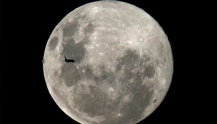 A plane is pictured in front of the full moon in Curitiba, Brazil February 8, 2020. —Reuters