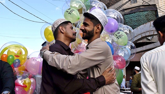 Faithful are exchanging Eid greetings with each other after offering Eid-ul-Fitr prayers in Karachi on April 23, 2023. —APP