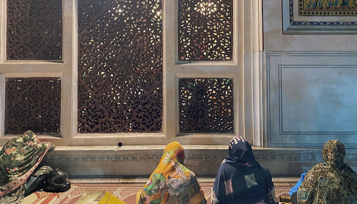Women praying outside the facade of the Mian Mir Shrine. Women are only allowed to visit outside the mazar. — Photo by author