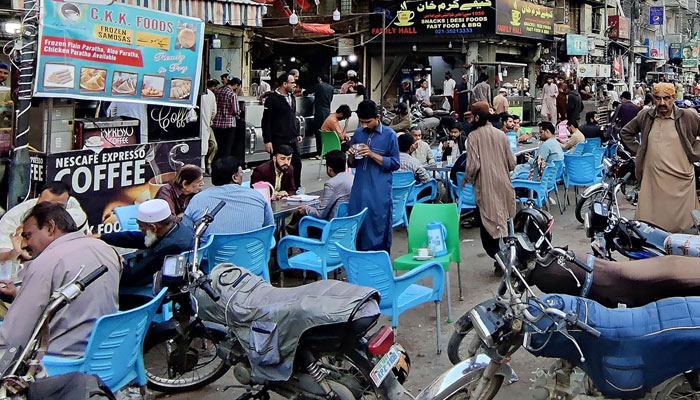 Motorcycles are seen parked outside a street in Saddar on March 4, 2024. — INP