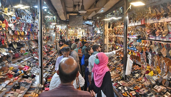 A representational image showing people busy in shopping activities at a market in Lahore. — AFP/File