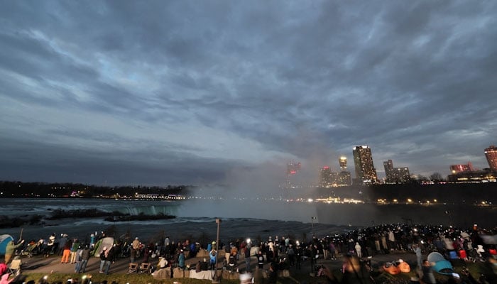 People assemble to view a total solar eclipse, where the moon will blot out the sun, at Niagara Falls, New York, U.S. April 8, 2024. REUTERS