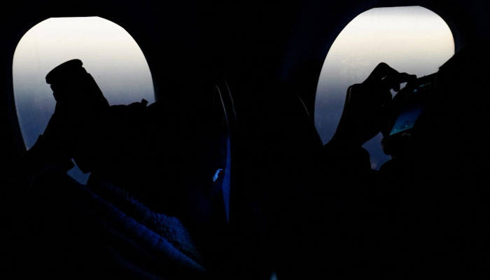 Passengers capture views of the eclipse, April 8, 2024. REUTERS