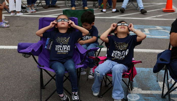 Children assemble to view a total solar eclipse, where the moon blots out the sun, in Eagle Pass, Texas, U.S. April 8, 2024. REUTERS