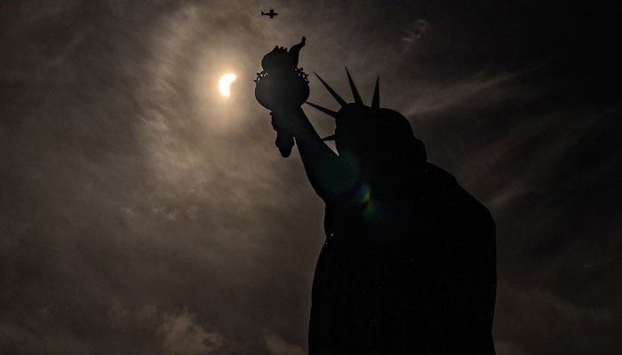 The Statue of Liberty during a partial solar eclipse in New York City REUTERS