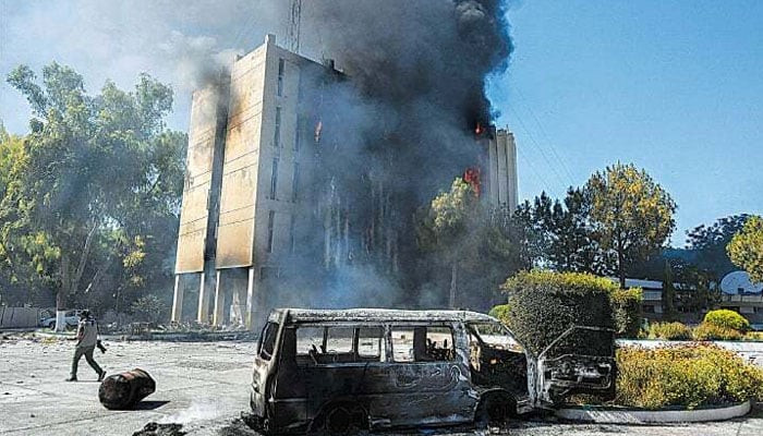 Black smoke billows from the Radio Pakistan building in Peshawar set ablaze by the PTI activists, on May 10, 2023.—AFP