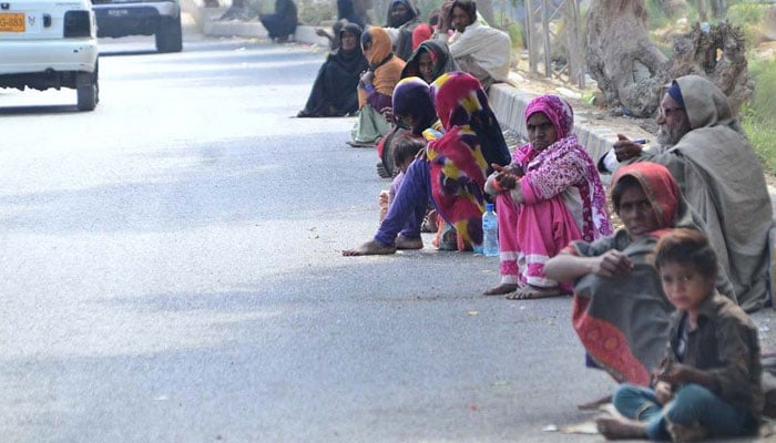 A large number of beggars sitting on the roadside waiting for mercy at Wahduwah road on February 10, 2022. — APP
