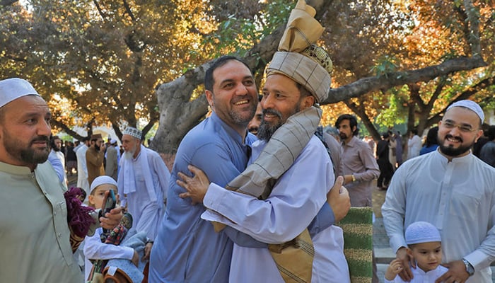 People greet each other as they attend Eid ul Fitr prayers to mark the end of the fasting month of Ramadan in Peshawar, on April 22, 2023. — Reuters