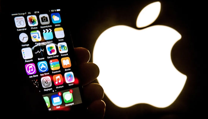 An illustration of an iPhone held up in front of the Apple Inc. logo. — AFP/File