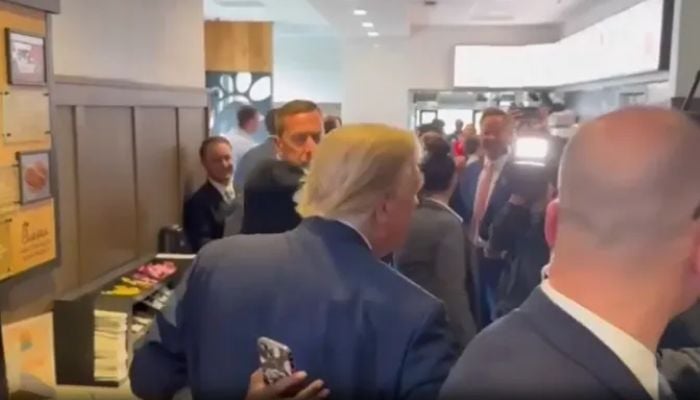 Donald Trump speaks with the staff of a restaurant in Atlanta, Georgia. — Margo Martin/Storyful